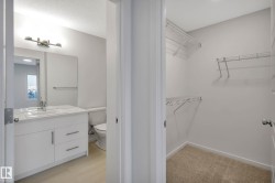 White vanity with integrated sink, chrome faucet, and storage drawers - 