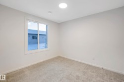 Recessed lighting, light-toned walls, and neutral carpet flooring - 