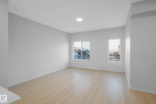 Recessed ceiling lighting, two windows, light wood-finish flooring, and white walls - 5239 - 5245 21A Avenue Sw, Edmonton, AB 