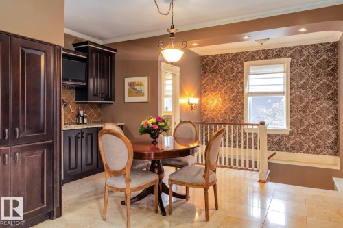 Dining room featuring crown molding and light tile patterned floors - 6306 111 Avenue Nw, Edmonton, AB 