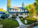 View of front of home featuring a front lawn and stone siding - 6306 111 Avenue Nw, Edmonton, AB 