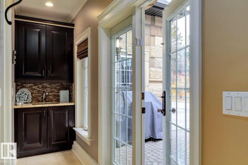 Entryway featuring plenty of natural light, tile patterned flooring, and crown molding - 6306 111 Avenue Nw, Edmonton, AB 