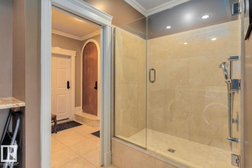 Full bath featuring tile patterned floors, crown molding, and a shower stall - 6306 111 Avenue Nw, Edmonton, AB 