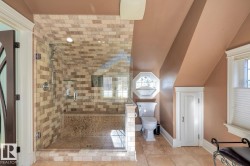 Full bath with lofted ceiling, a shower stall, healthy amount of natural light, and tile patterned flooring - 