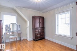 Bedroom featuring ornamental molding, light wood-style flooring, and a textured ceiling - 