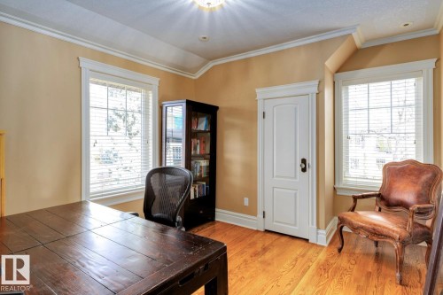 Office area with ornamental molding, plenty of natural light, light wood finished floors, and lofted ceiling - 6306 111 Avenue Nw, Edmonton, AB 