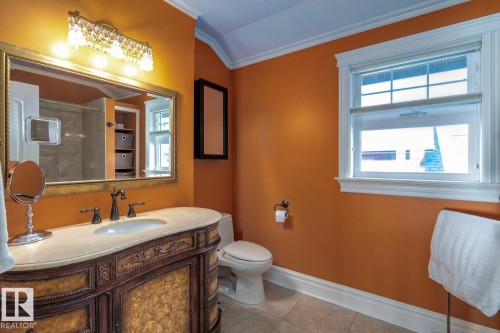 Full bathroom featuring ornamental molding, light tile patterned floors, vanity, plenty of natural light, and a shower - 6306 111 Avenue Nw, Edmonton, AB 