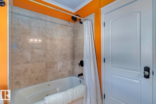 Full bath featuring ornamental molding and a combined bath / shower with jetted tub - 6306 111 Avenue Nw, Edmonton, AB 