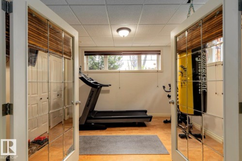 Workout room with a drop ceiling and wood finished floors - 6306 111 Avenue Nw, Edmonton, AB 