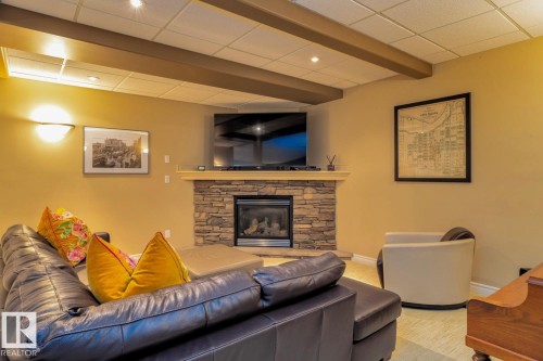 Living room with a fireplace and a drop ceiling - 6306 111 Avenue Nw, Edmonton, AB 
