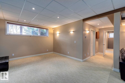 Below grade area featuring light carpet, recessed lighting, and a paneled ceiling - 6306 111 Avenue Nw, Edmonton, AB 