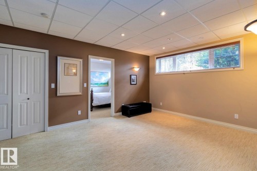 Basement with carpet flooring, a paneled ceiling, and recessed lighting - 6306 111 Avenue Nw, Edmonton, AB 