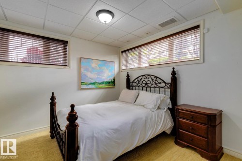 Bedroom featuring a paneled ceiling and light carpet - 6306 111 Avenue Nw, Edmonton, AB 