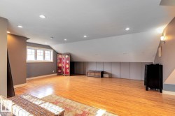 Additional living space with vaulted ceiling, light wood-type flooring, and recessed lighting - 