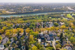 Aerial view of residential area featuring a large body of water - 