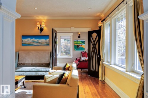 Bedroom with ornamental molding and wood finished floors - 6306 111 Avenue Nw, Edmonton, AB 
