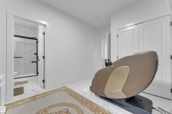 White tile flooring, white walls, double bi-fold closet doors, and an open doorway reveal a white-tiled bathroom with a glass-enclosed shower - 