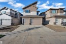 Modern architectural exterior with multi-toned siding, a distinct roofline, and an attached two-car garage featuring contemporary design elements - 6502 42 Ave, Beaumont, AB 