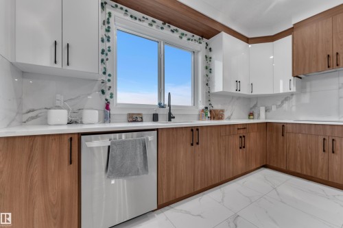Two-tone cabinetry with wood-finish lower cabinets and white upper cabinets - 6502 42 Ave, Beaumont, AB 