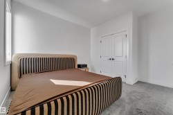 Window with white trim, light gray carpet, and white double doors - 