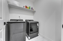 Laundry area featuring a wall-mounted shelf and tile flooring - 