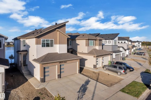 Contemporary exterior featuring mixed material siding, an attached two-car garage, and a sloped roofline - 6502 42 Ave, Beaumont, AB 