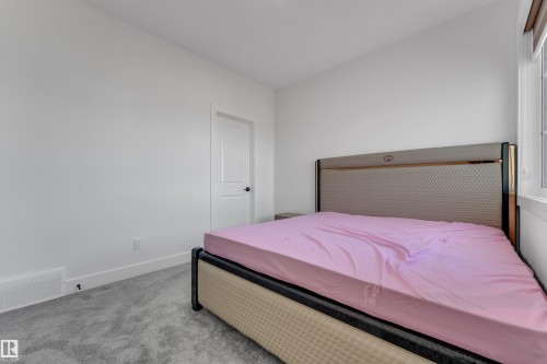 Wall-to-wall carpeting with light-colored walls and a window with blinds - 6502 42 Ave, Beaumont, AB 