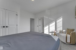 White walls, white doors with modern black hardware, and light carpet flooring - 