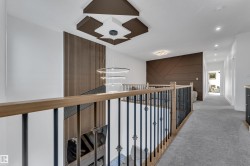 Upper-level hallway with carpet flooring and recessed lighting - 