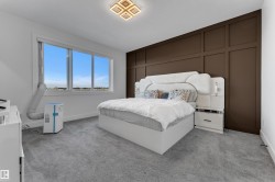 Expansive window offering abundant natural light, feature wall with panel molding, recessed lighting, and soft carpet flooring - 