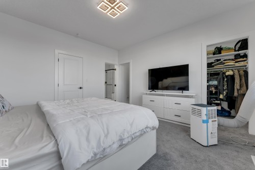 Recessed ceiling light fixture, white interior doors, and plush carpet flooring - 6502 42 Ave, Beaumont, AB 