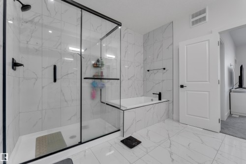 Walk-in shower with clear glass enclosure and black frame - 6502 42 Ave, Beaumont, AB 