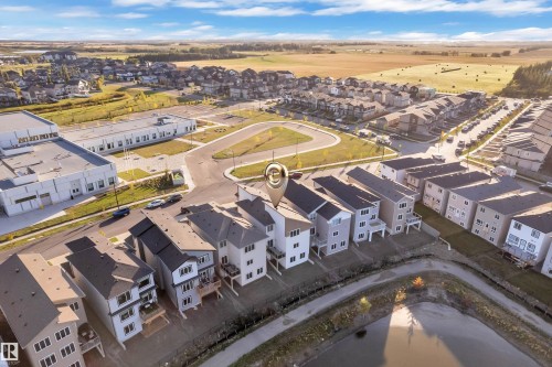 Aerial perspective of a developed residential area with multiple detached and attached properties - 6502 42 Ave, Beaumont, AB 