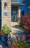 Stone facade with exterior lighting - 61 Encore Crescent, St. Albert, AB 