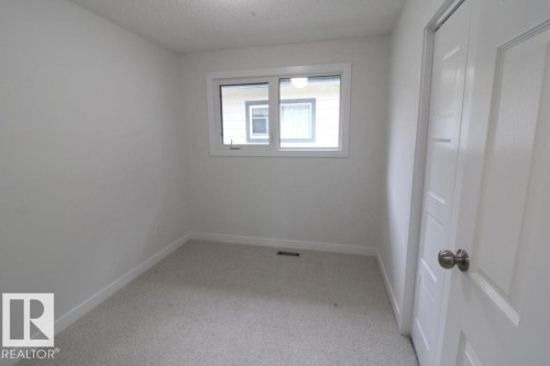 Light-colored carpeting, white walls, and a window with white trim - 44 Arlington Drive, St. Albert, AB 