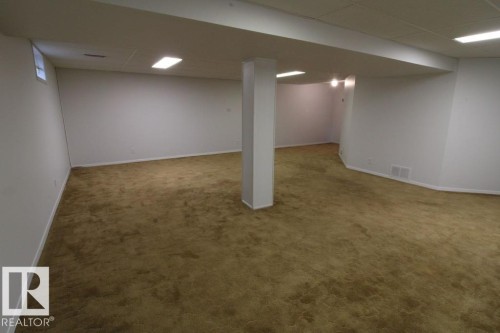 Expansive lower-level space with plush carpeting, recessed lighting, and a neutral color palette - 44 Arlington Drive, St. Albert, AB 