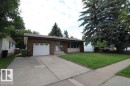 Brick exterior with a single-car garage and concrete driveway - 44 Arlington Drive, St. Albert, AB 