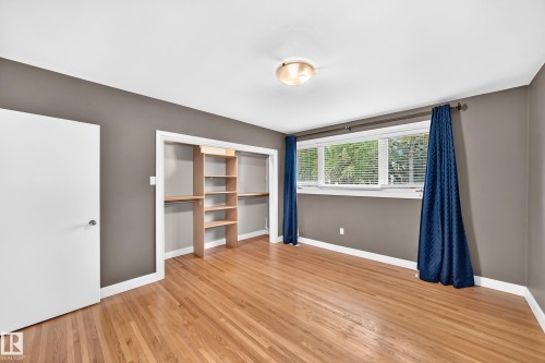 Hardwood flooring, recessed closet with built-in shelving, triple window, flush mount ceiling light - 10715 133 Street Nw, Edmonton, AB 