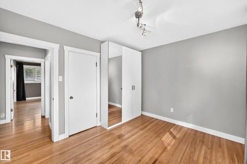 Wood-finish flooring with light gray wall paint and white trim - 10715 133 Street Nw, Edmonton, AB 
