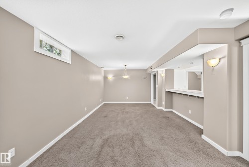 Recessed window, built-in bar, wall sconces, ceiling-mounted lighting, and carpet flooring - 10715 133 Street Nw, Edmonton, AB 