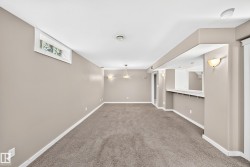 Recessed window, built-in bar, wall sconces, ceiling-mounted lighting, and carpet flooring - 