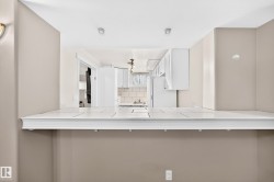 Kitchen pass-through with a tiled countertop and decorative trim - 