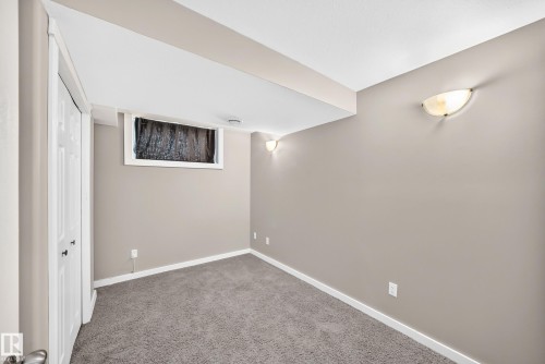 Neutral-toned walls complement the gray carpeting - 10715 133 Street Nw, Edmonton, AB 