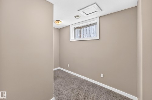 Recessed ceiling lighting, flush mount ceiling fixture, window with white trim, light taupe walls, and gray carpet - 10715 133 Street Nw, Edmonton, AB 