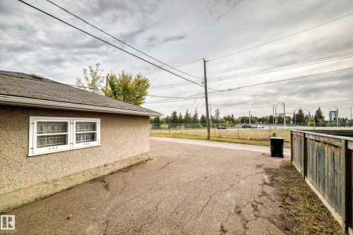 Stucco exterior with multi-pane windows and a shingle roof - 10715 133 Street Nw, Edmonton, AB 