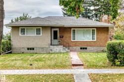 Brick and stucco exterior with a gray shingle roof - 