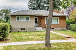Brick and stucco facade with a shingled roof - 