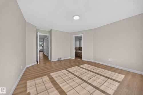 Wood-finish flooring, recessed ceiling lighting, and light gray wall paint - 7836 7 Ave Sw Sw, Edmonton, AB 