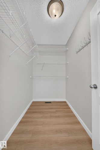 Recessed ceiling light, white wire shelving, wall-mounted coat hooks, wood-finish flooring, white trim - 7836 7 Ave Sw Sw, Edmonton, AB 