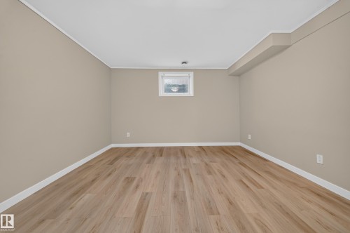 Recessed window, wood-finish flooring, light neutral wall color, white trim, ceiling soffit - 7836 7 Ave Sw Sw, Edmonton, AB 